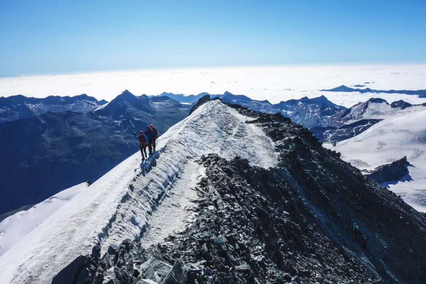 Z vrcholu můžete vidět všechny slavné vrcholy včetně Matterhornu a Mont Blancu. Hohlaubgrat, Allalinhorn, Wallis, Alpy, Švýcarsko.